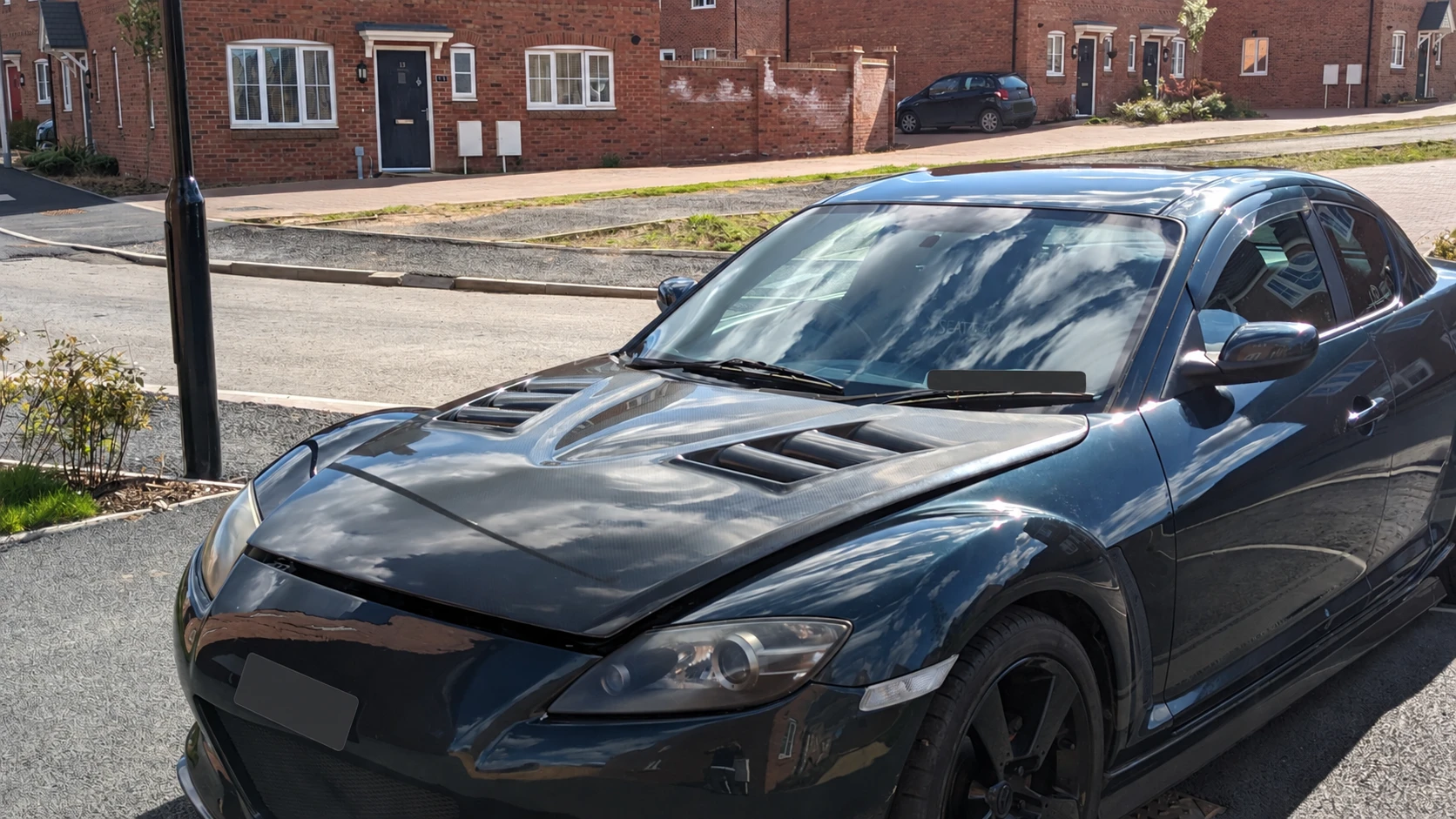 Iain’s Mazda RX-8 with a reflective carbon bonnet, registration details obscured